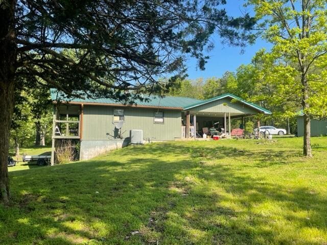 10694 Red Spring Rd, Mountain Grove, MO 65711 - back of house with a yard and central AC