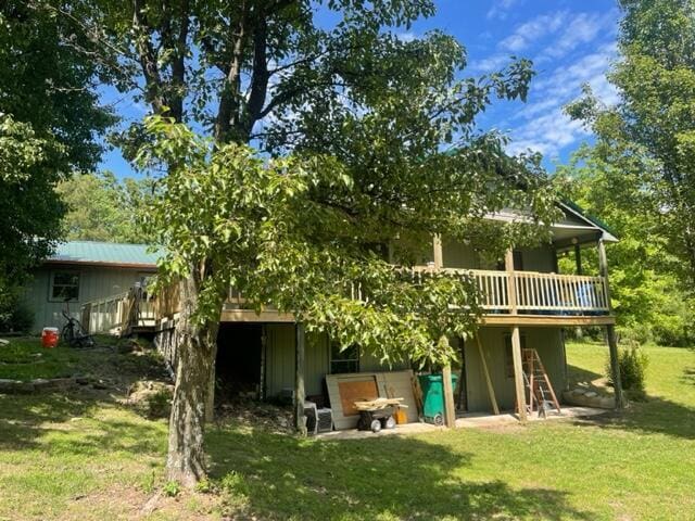 10694 Red Spring Rd, Mountain Grove, MO 65711 - rear view of house with a wooden deck and a lawn
