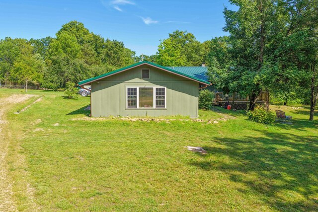 10694 Red Spring Rd, Mountain Grove, MO 65711 - view of side of property featuring a yard, a wooden deck, and metal roof