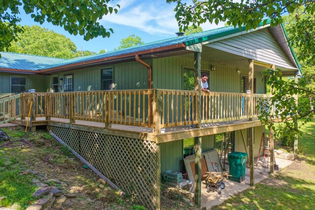 10694 Red Spring Rd, Mountain Grove, MO 65711 - rear view of house featuring a deck, metal roof, and a patio area