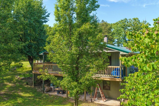 10694 Red Spring Rd, Mountain Grove, MO 65711 - back of house with a wooden deck, a chimney, a yard, and a patio area