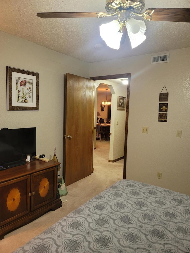 150 Sunken Forest Dr Unit 235, Forsyth, MO 65653 - bedroom with arched walkways, light colored carpet, ceiling fan, and a textured ceiling