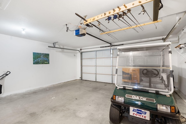 131 Lake Beach Ln, Hollister, MO 65672 - garage featuring a garage door opener and baseboards