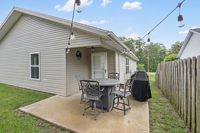 131 Lake Beach Ln, Hollister, MO 65672 - rear view of house featuring a fenced backyard, a patio area, and outdoor dining space