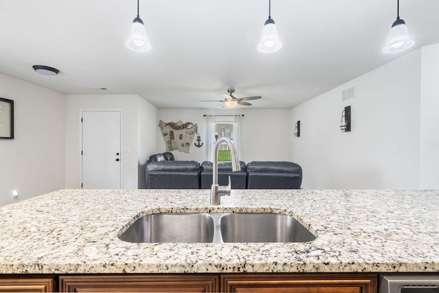 131 Lake Beach Ln, Hollister, MO 65672 - kitchen featuring a sink, open floor plan, ceiling fan, light stone countertops, and pendant lighting