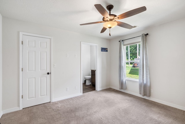 131 Lake Beach Ln, Hollister, MO 65672 - unfurnished bedroom with carpet flooring, ensuite bathroom, baseboards, and a ceiling fan