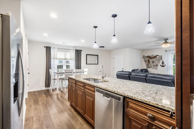 131 Lake Beach Ln, Hollister, MO 65672 - kitchen with stainless steel appliances, a sink, healthy amount of natural light, light wood finished floors, and recessed lighting