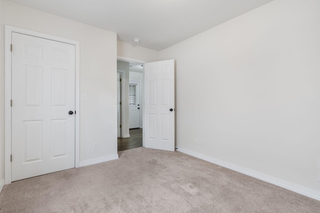 131 Lake Beach Ln, Hollister, MO 65672 - unfurnished bedroom featuring carpet flooring and baseboards