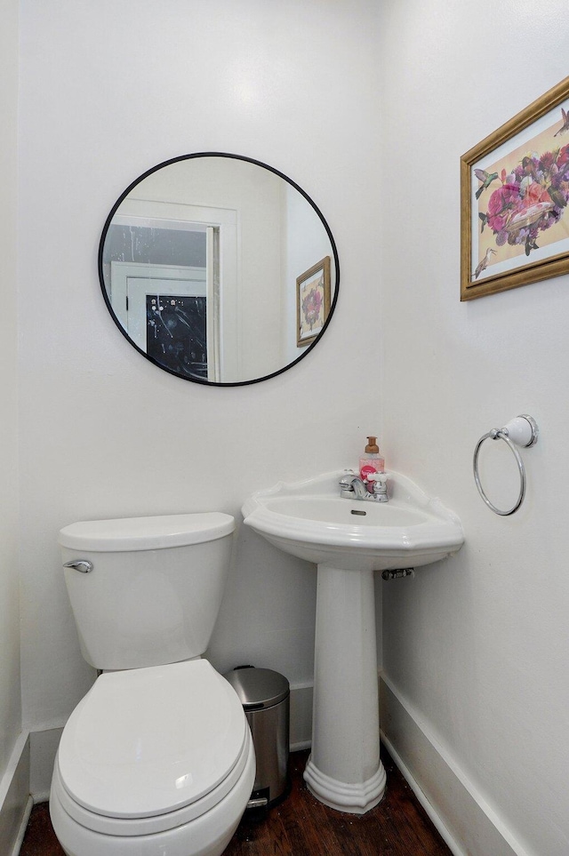 1501 E Walnut St, Springfield, MO 65802 - half bath with wood finished floors, baseboards, toilet, and a sink