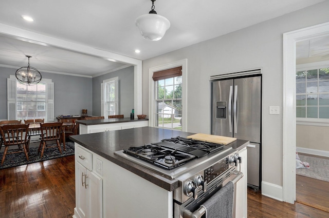 1501 E Walnut St, Springfield, MO 65802 - kitchen featuring stainless steel appliances, dark countertops, dark wood finished floors, healthy amount of natural light, and crown molding