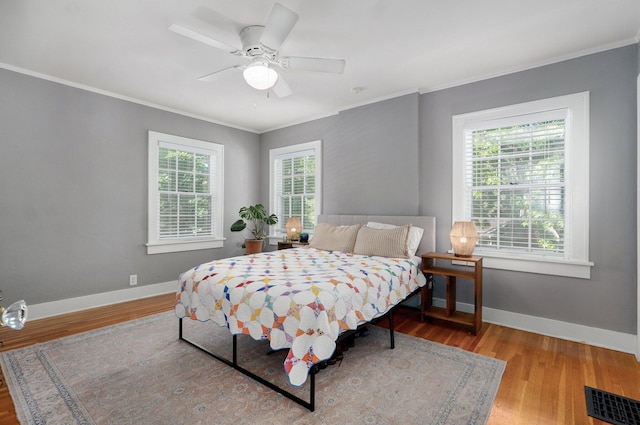 1501 E Walnut St, Springfield, MO 65802 - bedroom featuring multiple windows, ornamental molding, wood finished floors, and baseboards
