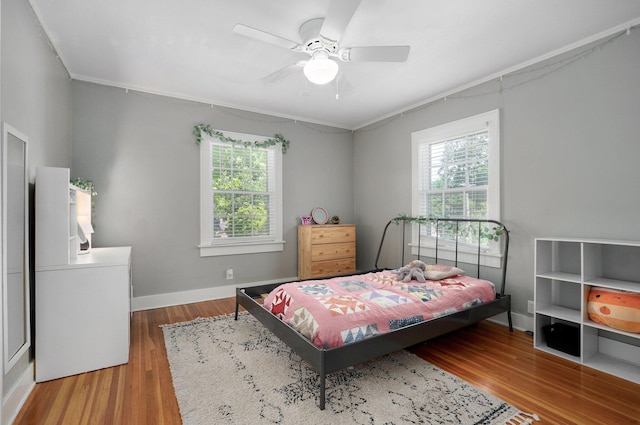 1501 E Walnut St, Springfield, MO 65802 - bedroom featuring multiple windows, wood finished floors, ornamental molding, baseboards, and a ceiling fan