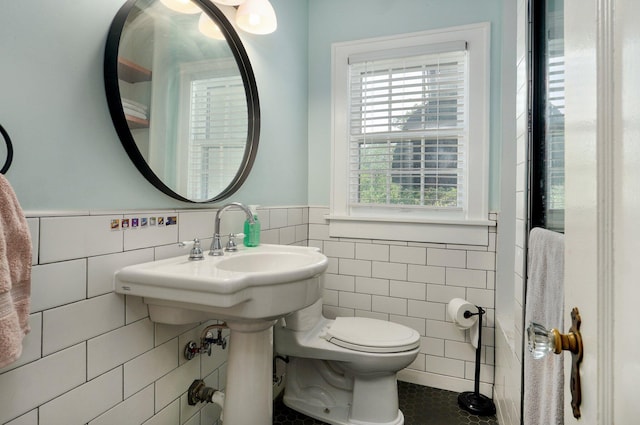 1501 E Walnut St, Springfield, MO 65802 - bathroom with tile walls, toilet, tile patterned floors, and a wainscoted wall