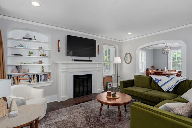 1501 E Walnut St, Springfield, MO 65802 - living area featuring ornamental molding, a chandelier, recessed lighting, arched walkways, and a brick fireplace