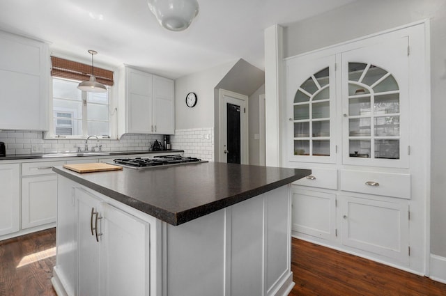 1501 E Walnut St, Springfield, MO 65802 - kitchen featuring dark countertops, a sink, and decorative backsplash