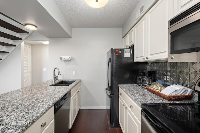 10 Treehouse Ln Unit 11, Branson, MO 65616 - kitchen featuring stainless steel appliances, dark wood-style flooring, a sink, light stone countertops, and a textured ceiling