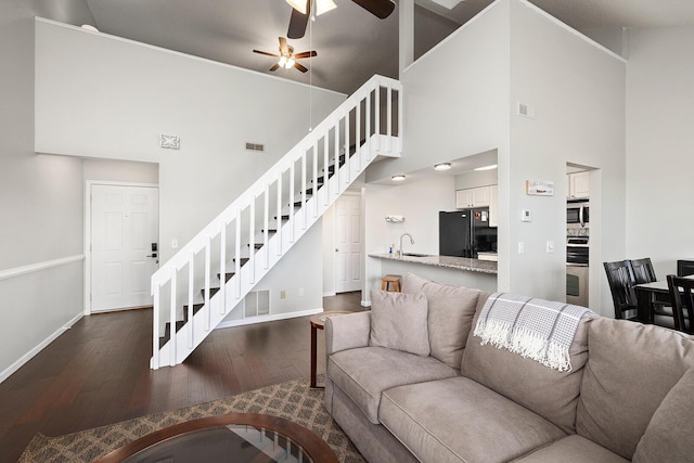 10 Treehouse Ln Unit 11, Branson, MO 65616 - living room with stairway, high vaulted ceiling, baseboards, dark wood-style floors, and ceiling fan