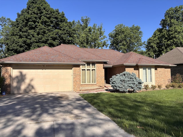 view of front of home with brick siding, a front lawn, concrete driveway, and a garage