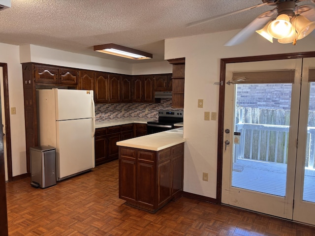 kitchen with electric range oven, freestanding refrigerator, under cabinet range hood, a textured ceiling, and dark brown cabinetry