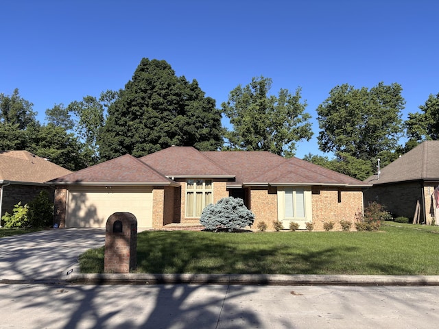 view of front of house featuring an attached garage, brick siding, concrete driveway, and a front yard