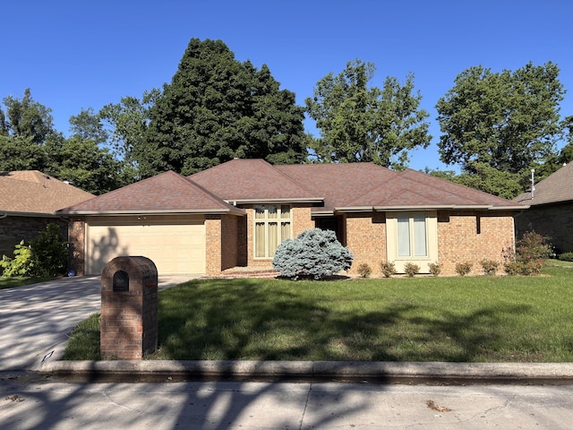 view of front of house with brick siding, a garage, a front yard, and concrete driveway