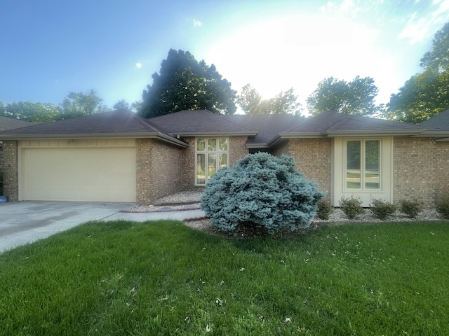 3055 S Oak Ave, Springfield, MO 65804 - view of front of house with brick siding, a garage, a front yard, and concrete driveway