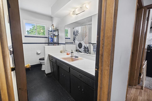 103 W Mockingbird Ln, Crane, MO 65633 - full bathroom featuring toilet, vanity, tile walls, a wainscoted wall, and wood finished floors