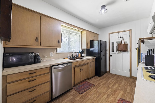103 W Mockingbird Ln, Crane, MO 65633 - kitchen with black appliances, a sink, light wood-style floors, and light countertops