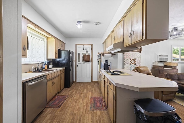 103 W Mockingbird Ln, Crane, MO 65633 - kitchen with white appliances, under cabinet range hood, a sink, and light wood-style flooring
