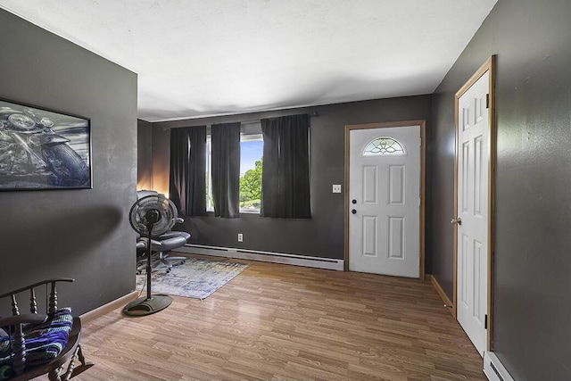 103 W Mockingbird Ln, Crane, MO 65633 - entryway with a baseboard radiator, a baseboard heating unit, wood finished floors, and baseboards