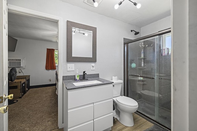 103 W Mockingbird Ln, Crane, MO 65633 - bathroom with vanity, a shower stall, toilet, and wood finished floors