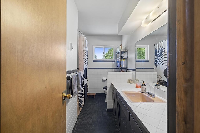 103 W Mockingbird Ln, Crane, MO 65633 - full bathroom with toilet, vanity, tile patterned flooring, a wainscoted wall, and a shower with curtain