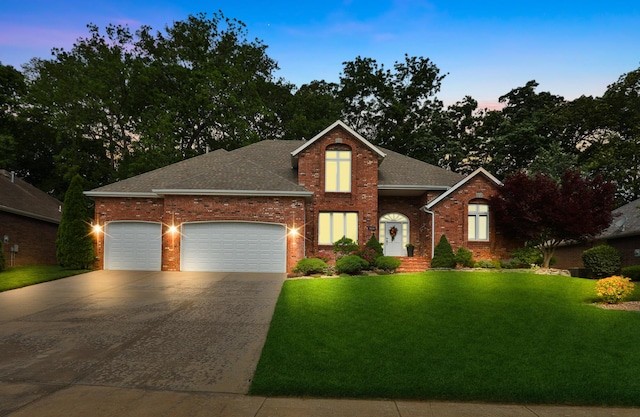 2539 S Forrest Heights Ave, Springfield, MO 65809 - traditional home with concrete driveway, brick siding, a front yard, a garage, and a shingled roof