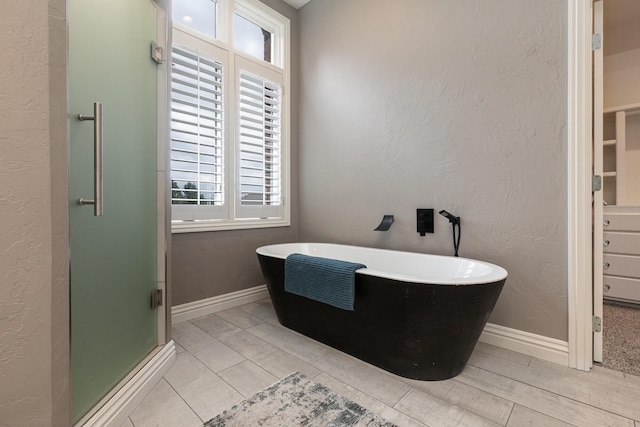 2539 S Forrest Heights Ave, Springfield, MO 65809 - bathroom featuring a soaking tub, a shower stall, and a textured wall