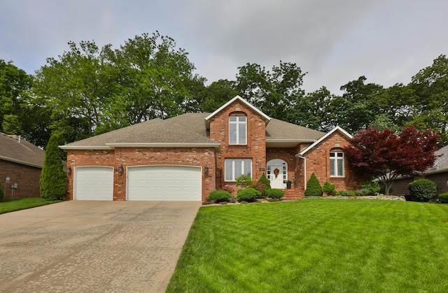 2539 S Forrest Heights Ave, Springfield, MO 65809 - traditional-style house featuring driveway, brick siding, a front yard, an attached garage, and roof with shingles