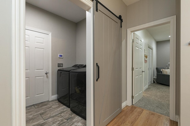 2539 S Forrest Heights Ave, Springfield, MO 65809 - laundry room with independent washer and dryer, a barn door, and light wood-style floors