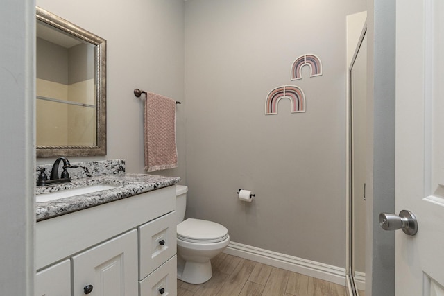 2539 S Forrest Heights Ave, Springfield, MO 65809 - full bathroom with toilet, vanity, wood finished floors, baseboards, and a shower