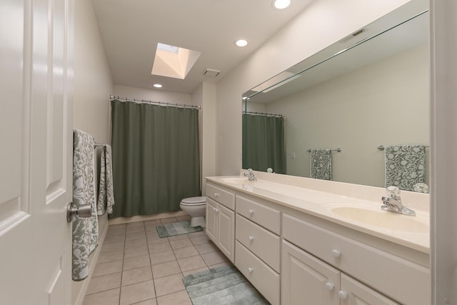 2539 S Forrest Heights Ave, Springfield, MO 65809 - bathroom featuring a skylight, tile patterned floors, double vanity, toilet, and recessed lighting