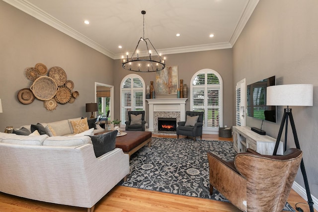 2539 S Forrest Heights Ave, Springfield, MO 65809 - living room with a chandelier, wood finished floors, a lit fireplace, recessed lighting, and ornamental molding
