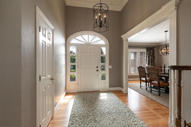 2539 S Forrest Heights Ave, Springfield, MO 65809 - foyer entrance featuring a chandelier, a textured wall, light wood-type flooring, crown molding, and baseboards