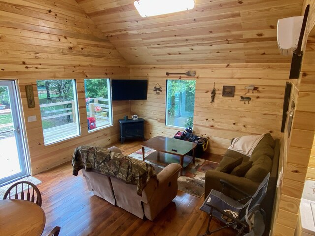 213 Spring Lake Dr, Mammoth Spring, AR 72554 - living area with vaulted ceiling, wooden walls, wooden ceiling, hardwood / wood-style flooring, and a wood stove