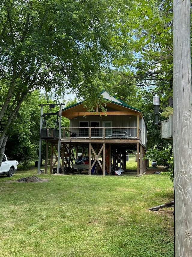 213 Spring Lake Dr, Mammoth Spring, AR 72554 - rear view of house featuring a lawn and stairs