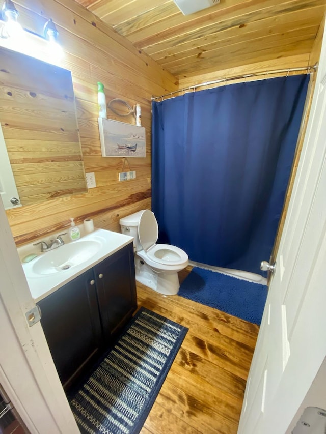 213 Spring Lake Dr, Mammoth Spring, AR 72554 - full bathroom with wooden walls, vanity, toilet, curtained shower, and wood finished floors