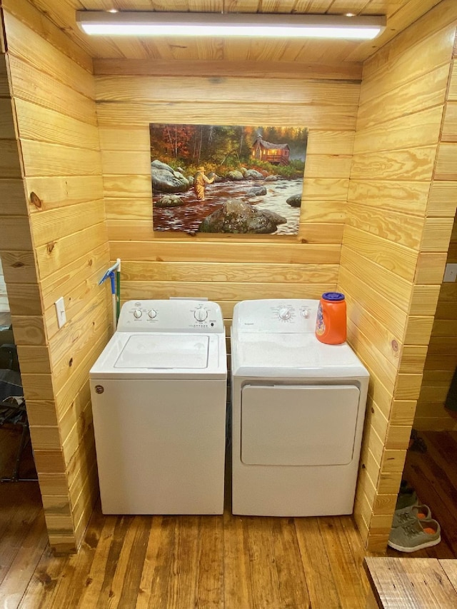 213 Spring Lake Dr, Mammoth Spring, AR 72554 - laundry room with washer and clothes dryer, wooden walls, and hardwood / wood-style floors