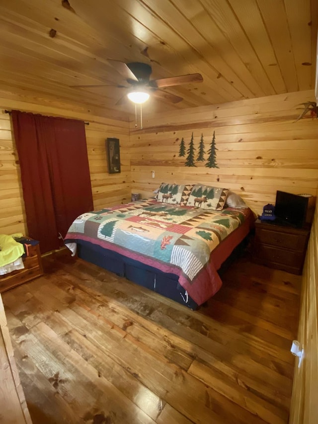 213 Spring Lake Dr, Mammoth Spring, AR 72554 - bedroom with wood ceiling, wood-type flooring, wood walls, and ceiling fan