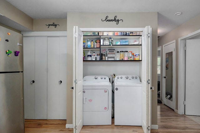 1511 E University St, Springfield, MO 65804 - laundry area with washer and dryer and light wood-style flooring