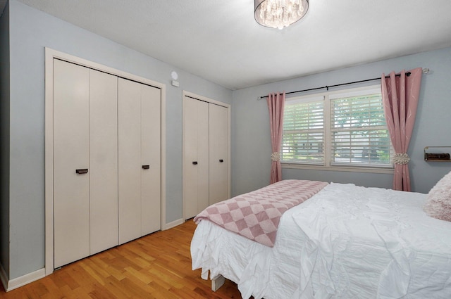 1511 E University St, Springfield, MO 65804 - bedroom featuring two closets and light wood-style floors