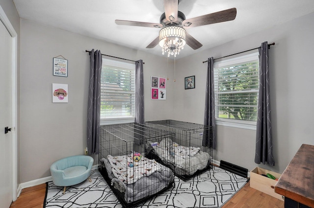 1511 E University St, Springfield, MO 65804 - bedroom with wood finished floors, baseboards, and a ceiling fan