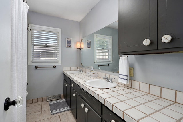 1511 E University St, Springfield, MO 65804 - full bathroom with double vanity, toilet, and tile patterned flooring