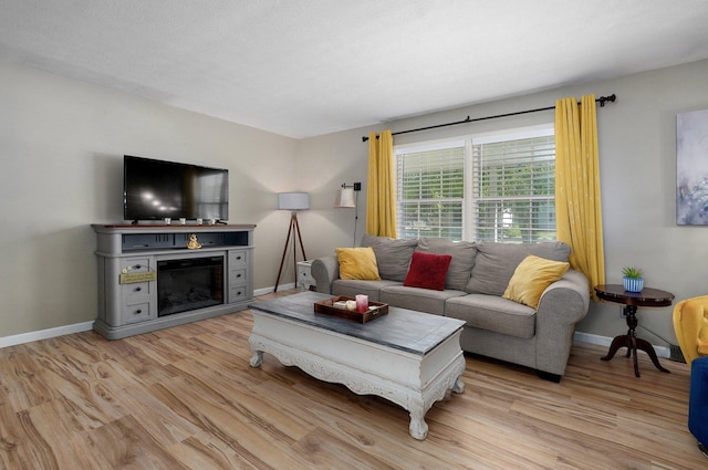1511 E University St, Springfield, MO 65804 - living area featuring light wood finished floors, a fireplace, and baseboards